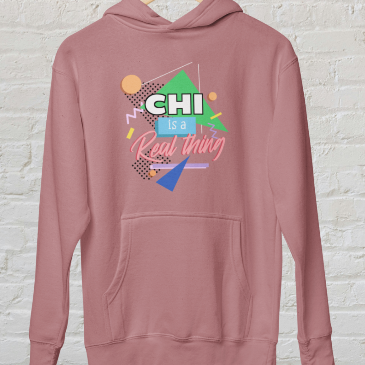hoodie dusty rose 'Chi is a real thing' design white brick backround