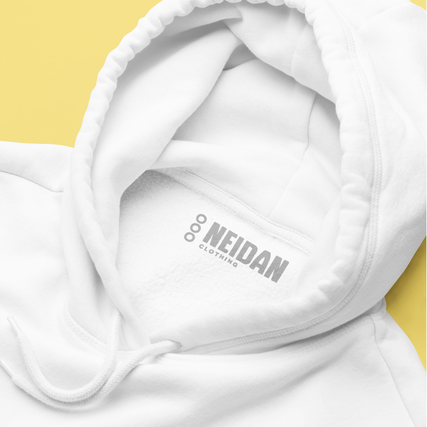 close up of a white hoodie neck label with neidan clothing logo