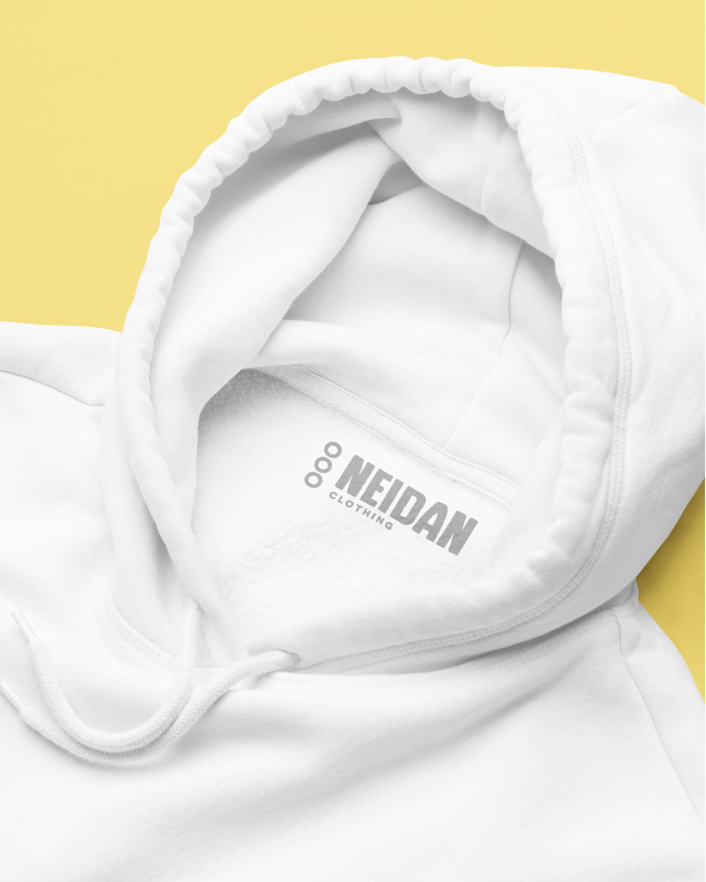 close up of a white hoodie neck label with neidan clothing logo