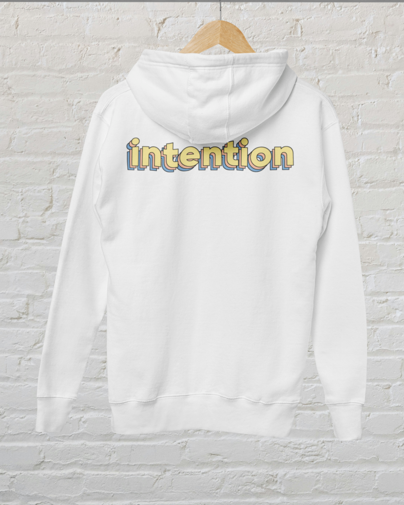 back view of a white zip up hoodie with intention written in 3 D lettering across the upper back