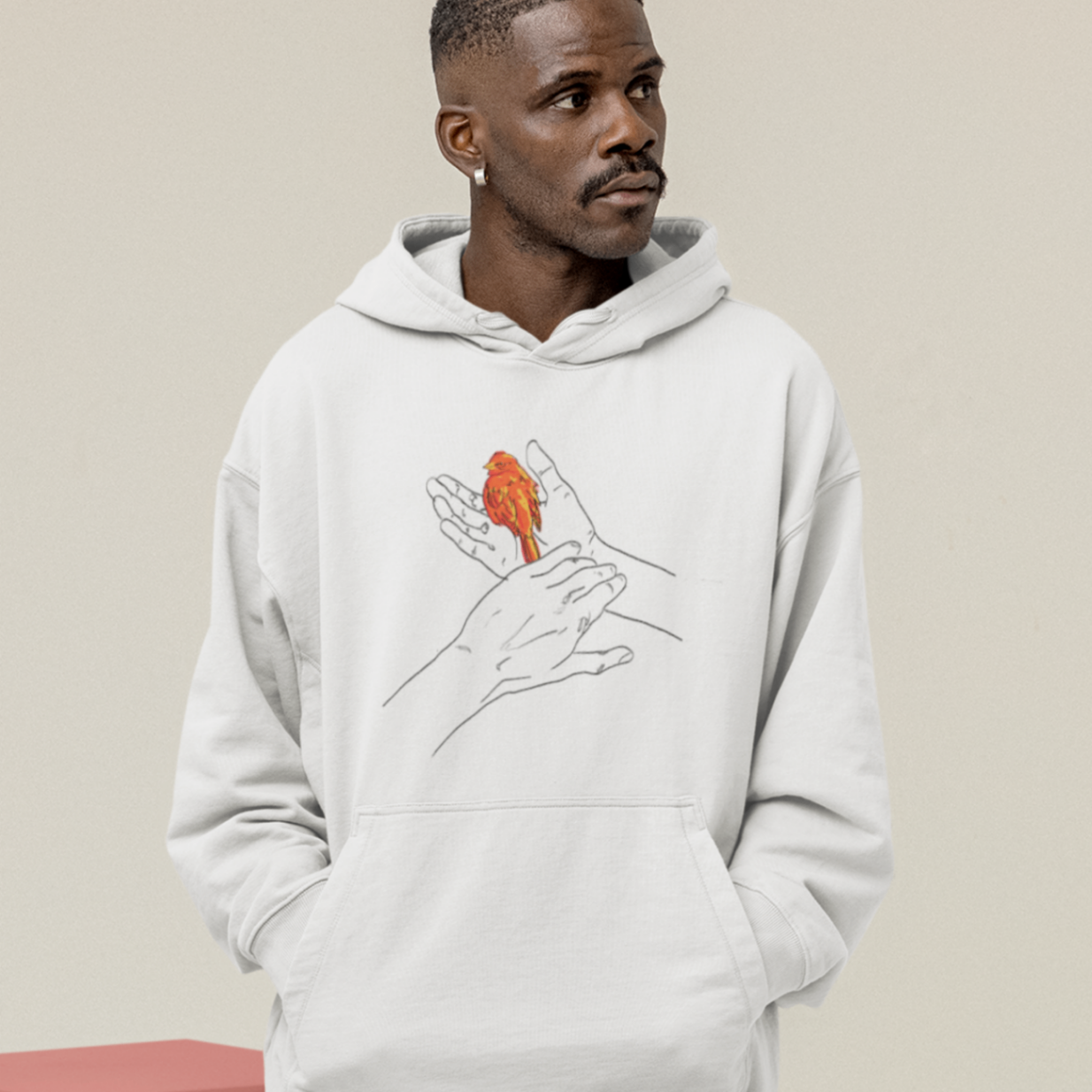 a cool looking man wearing an oversized white hoodie with the grasp sparrows tail design on front