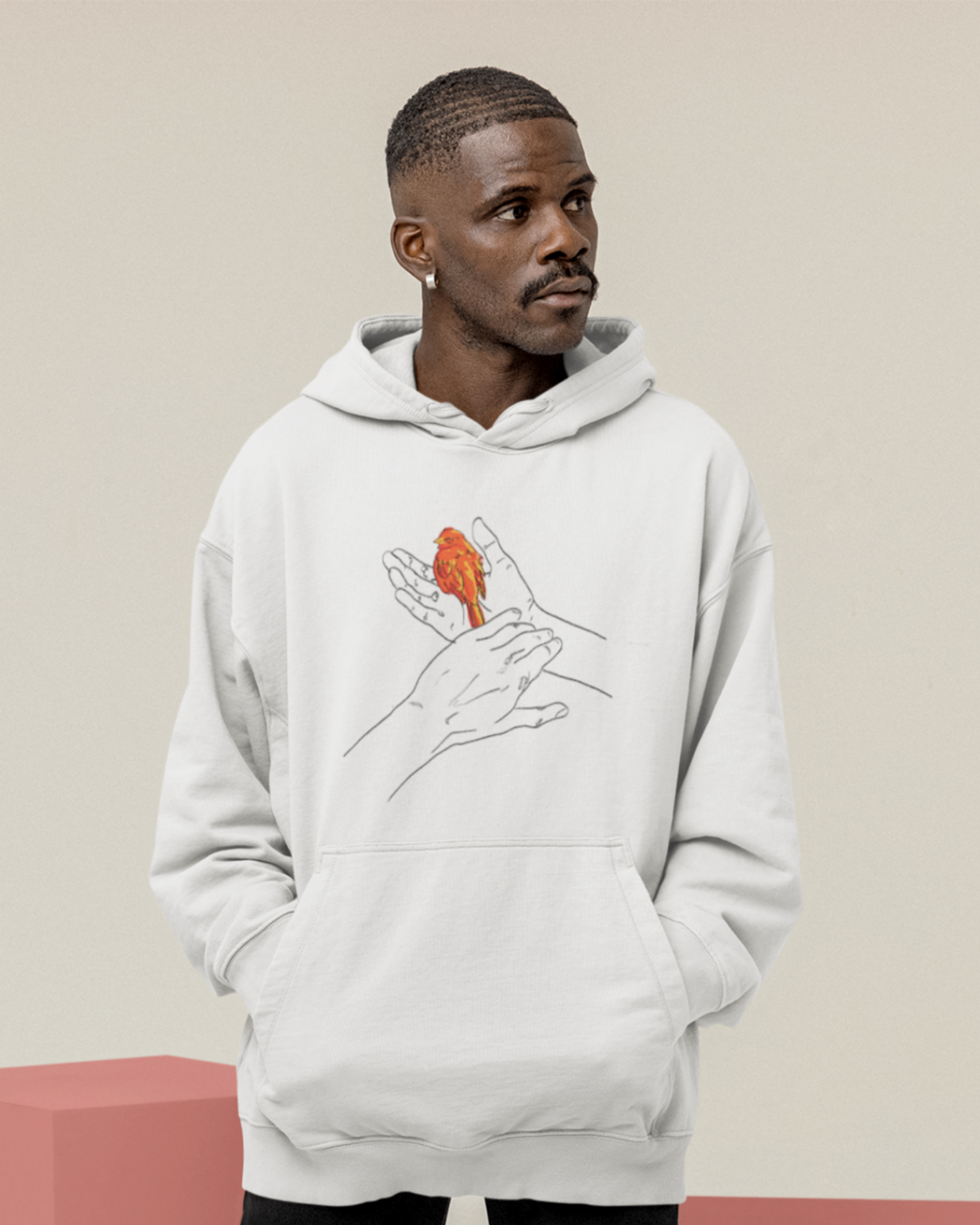a cool looking man wearing an oversized white hoodie with the grasp sparrows tail design on front