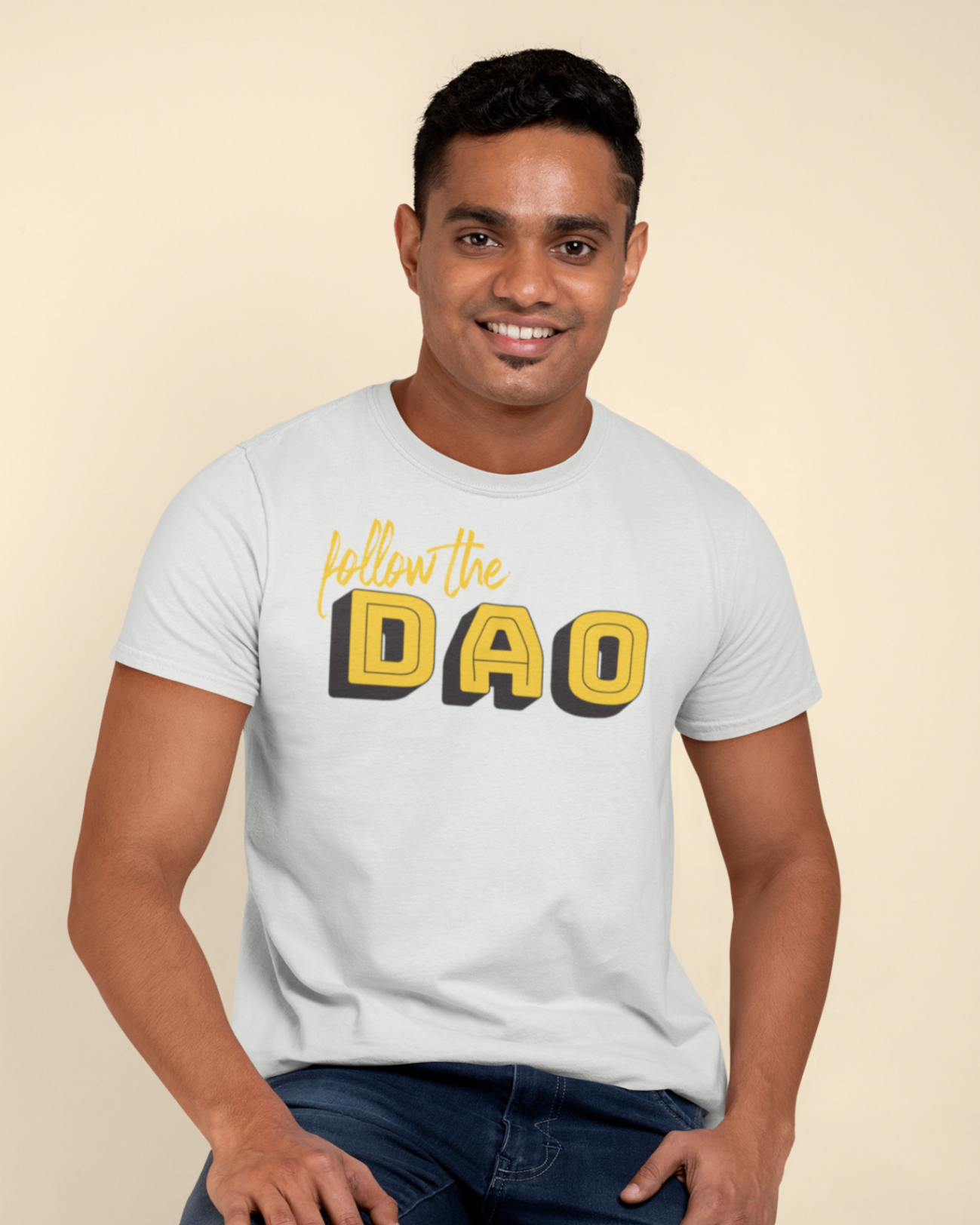 a calm man sitting wearing a white t shirt with follow the dao design in black and yellow
