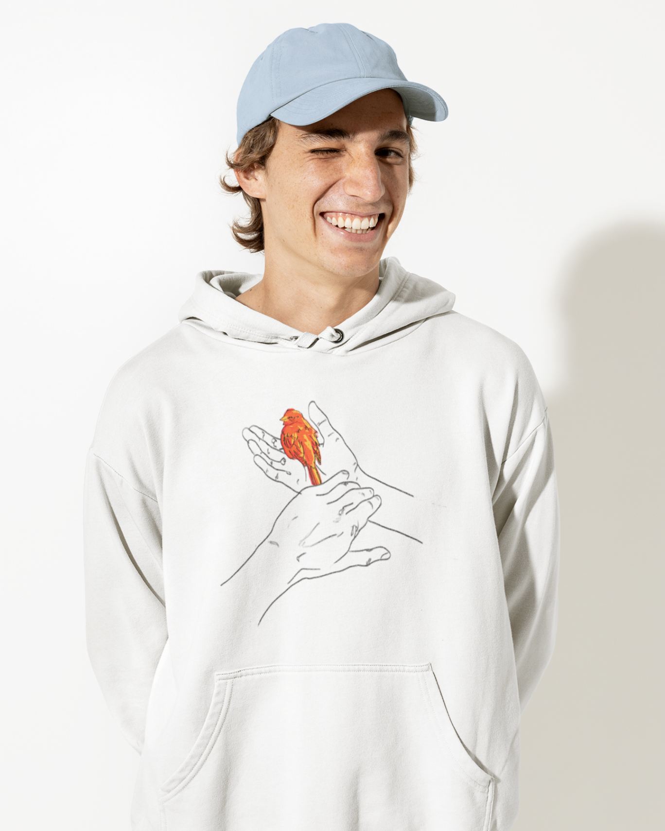a male model smiling widely wearing a white hoodie with grasp sparrows design on front