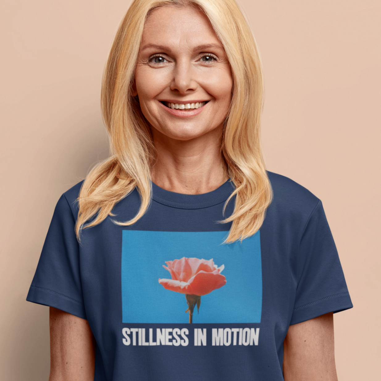 a smiling happy woman wearing a navy stillness in motion t shirt
