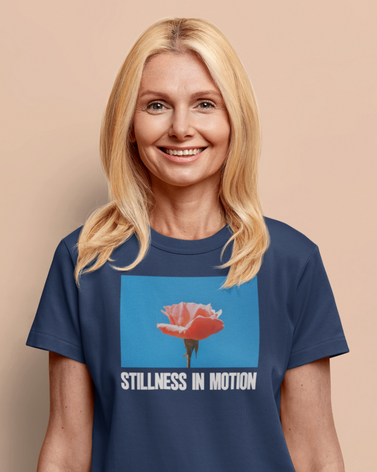 a smiling happy woman wearing a navy stillness in motion t shirt
