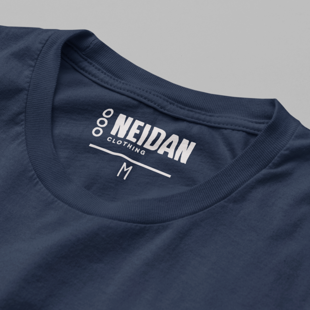closeup of a navy t shirt neck label with neidan clothing logo