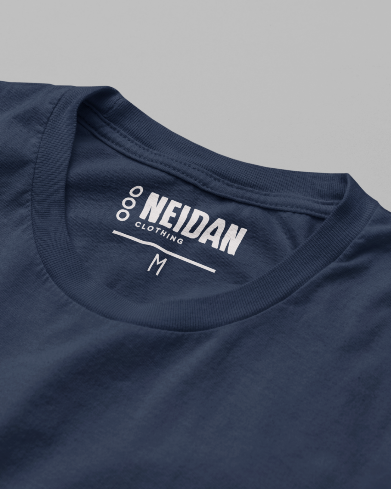 closeup of a navy t shirt neck label with neidan clothing logo