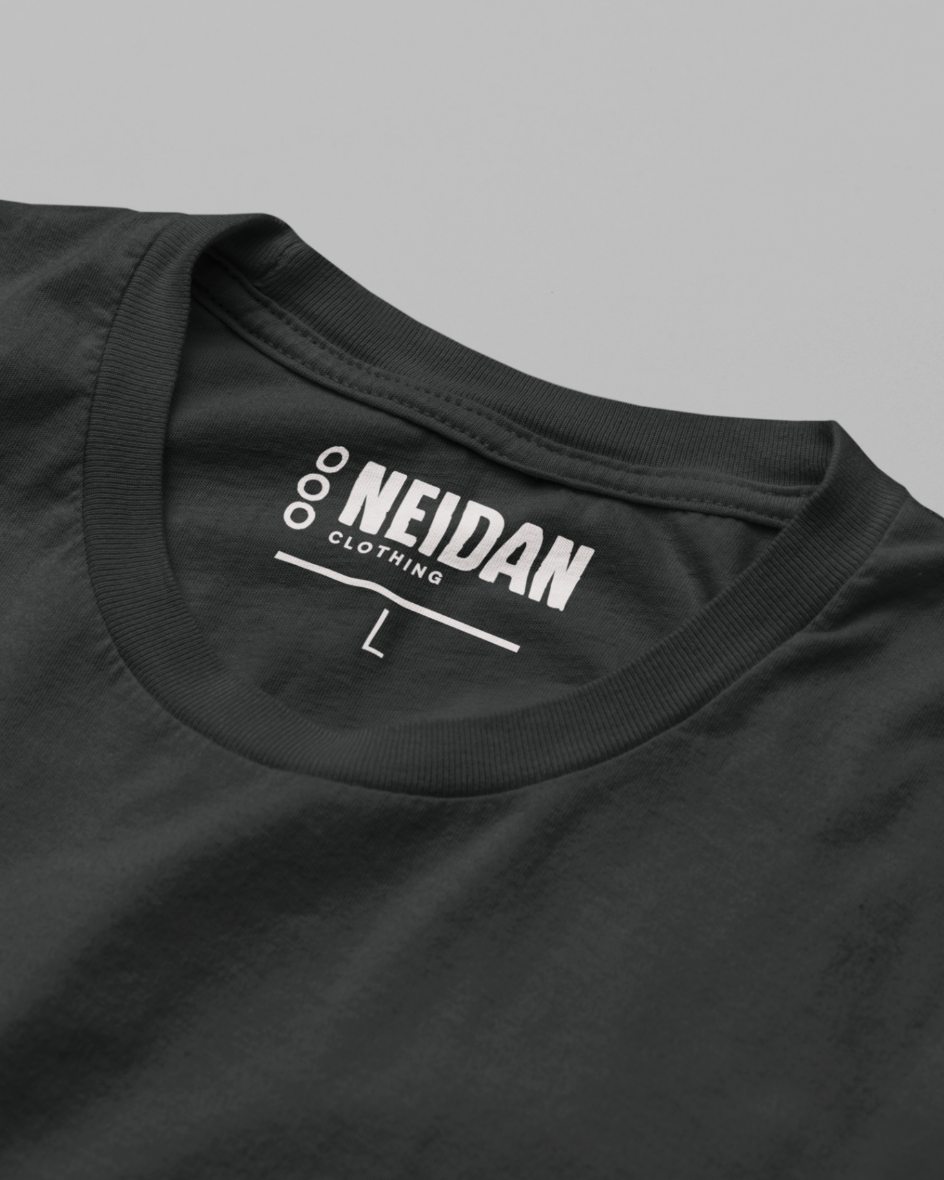 closeup of a black t shirt neck label with the neidan clothing label