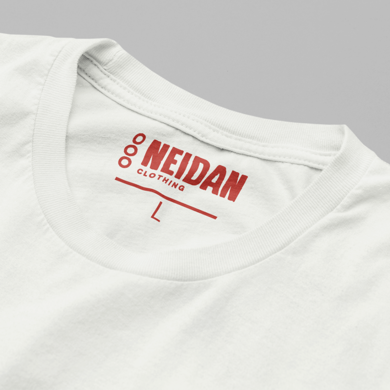 closeup of a white t shirt neck label with the neidan clothing logo