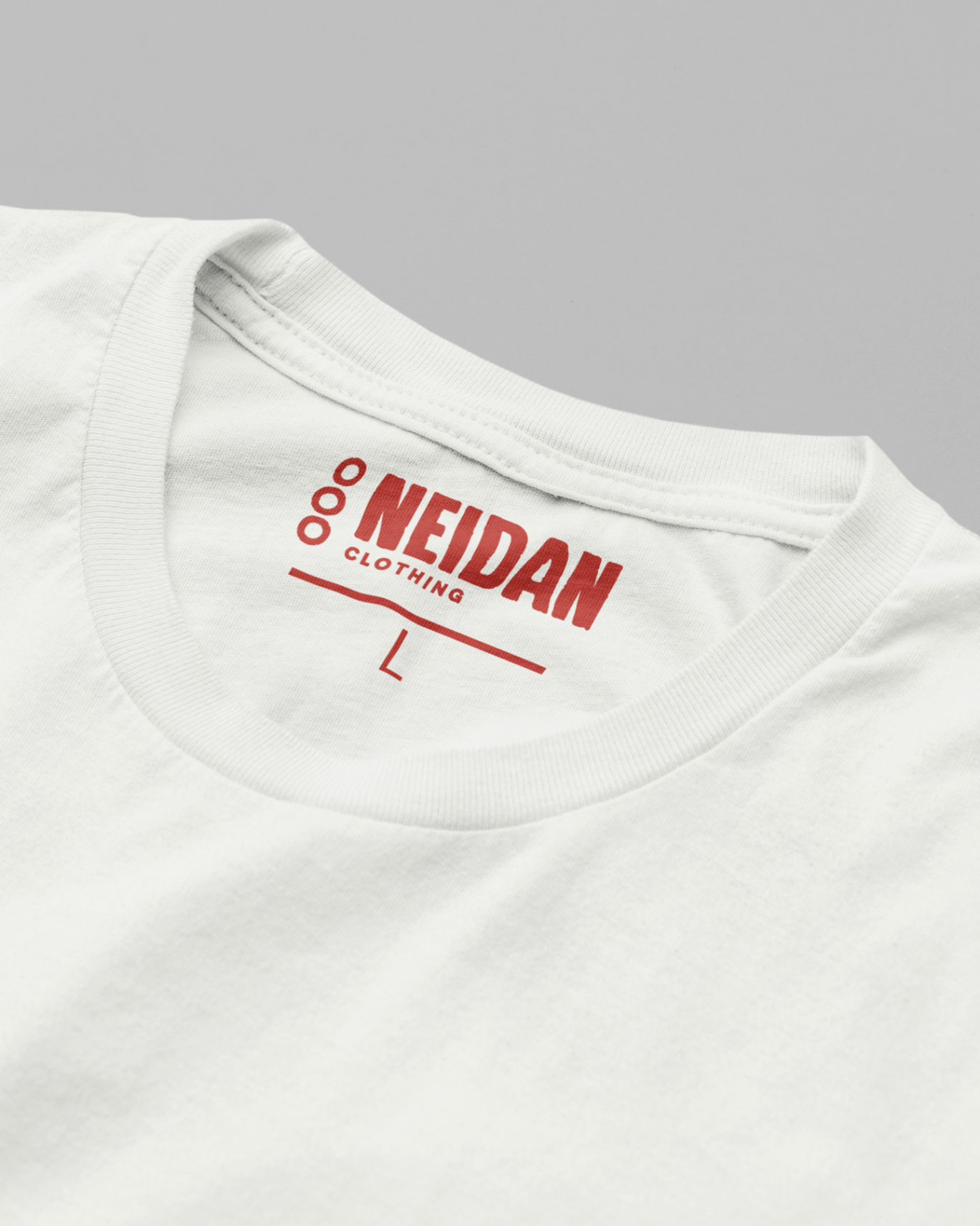 closeup of a white t shirt neck label with the neidan clothing logo